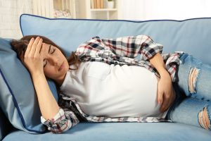生病的孕妇躺在沙发上